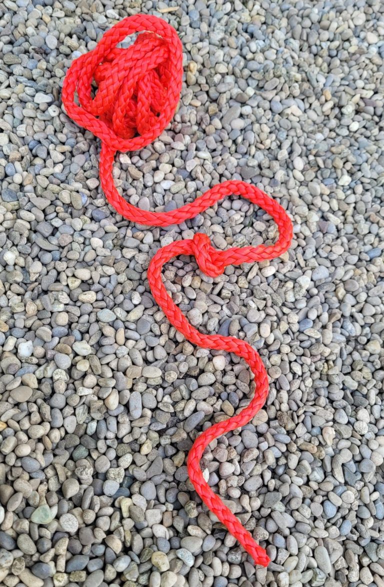 Ein rotes Fadenknäuel, das sich nach unten entwickelt